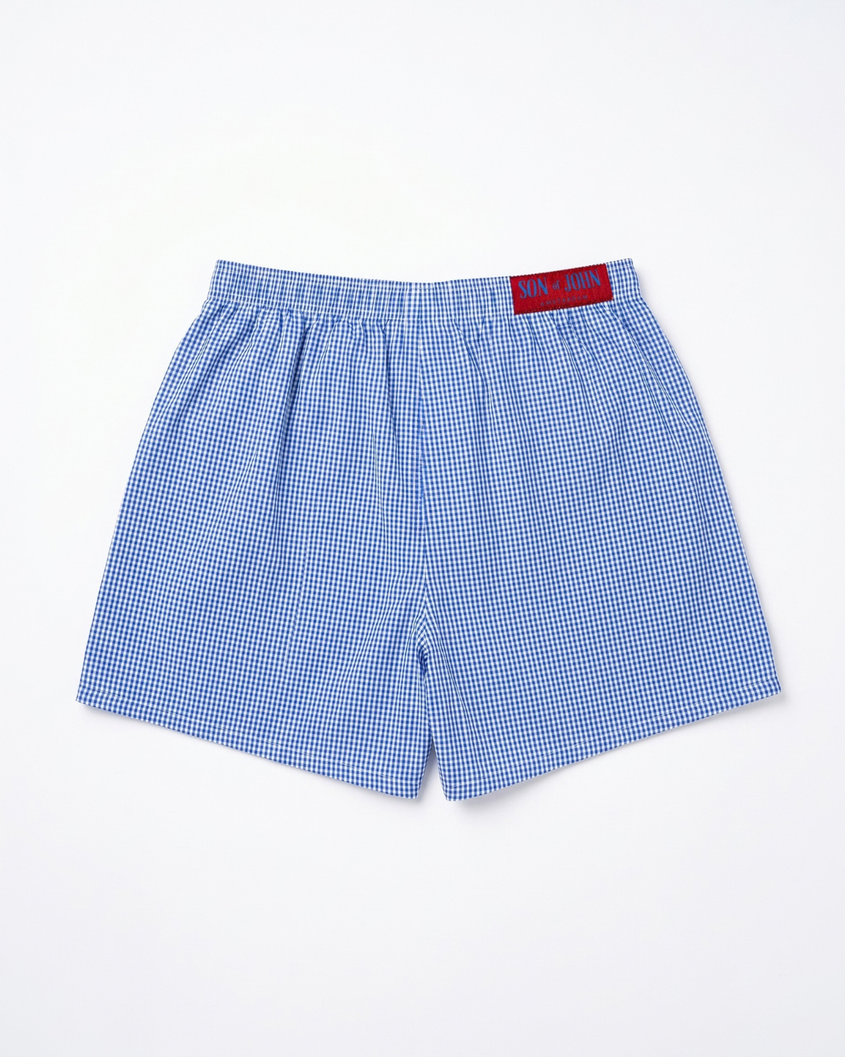 Back of the Son of John Marine Gingham boxer shorts with the dark red label, flat lay