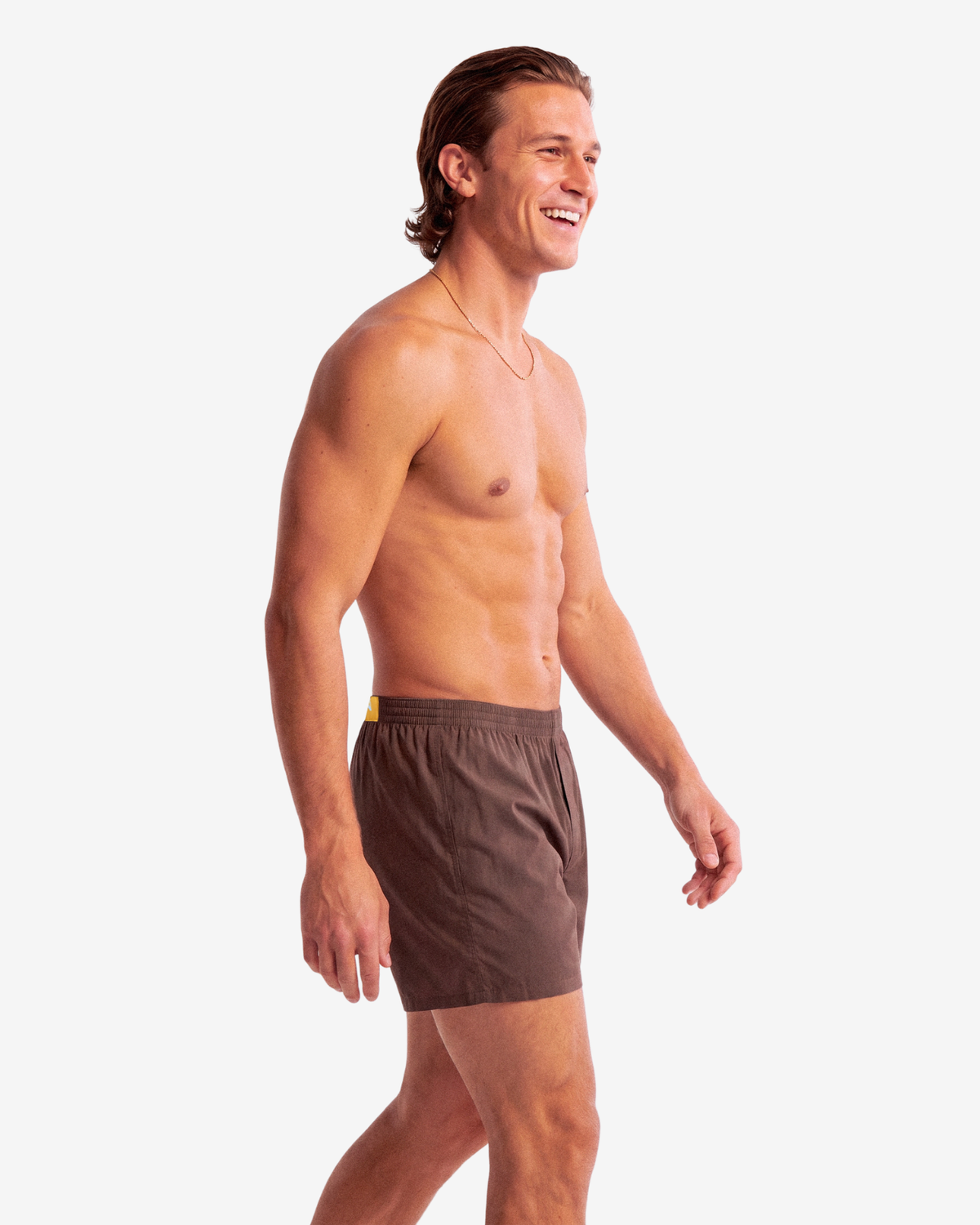 Model walking in Son of John Espresso Brown boxer shorts, side view