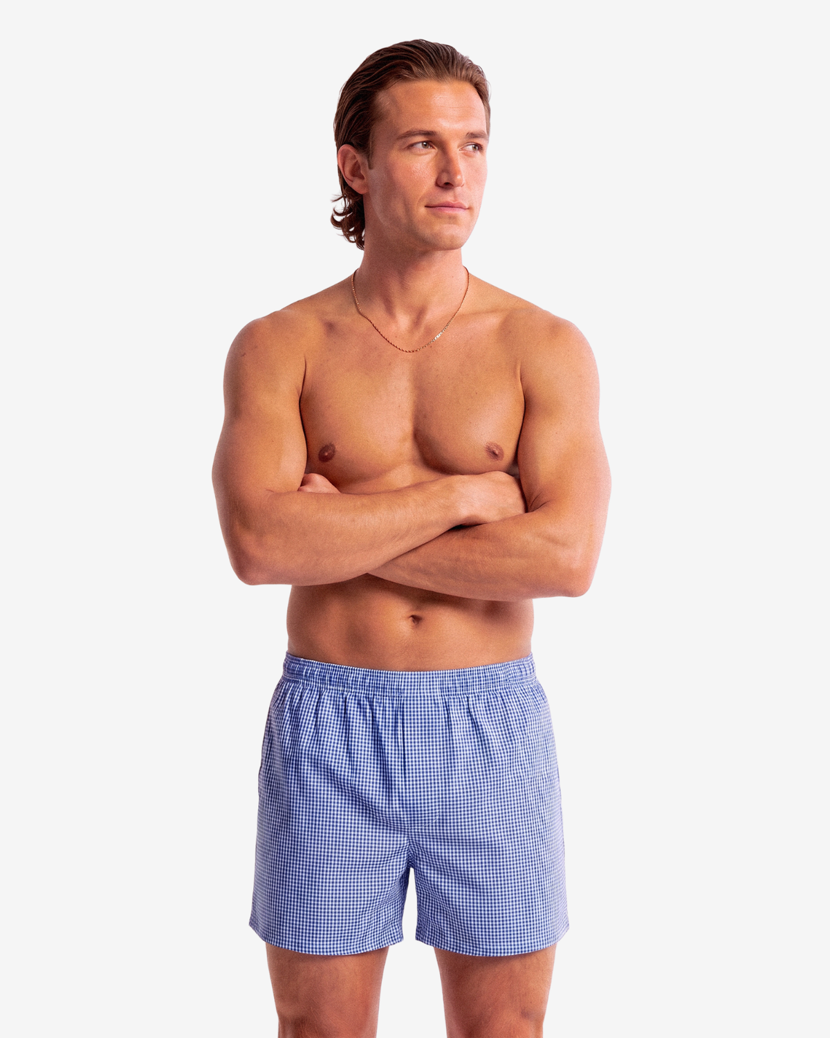 Model with crossed arms wearing Son of John Marine Gingham boxer shorts, front view